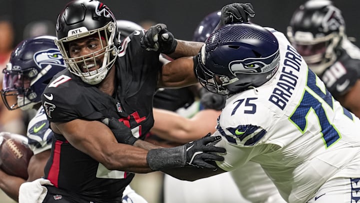 Dec 7, 2025; Atlanta, Georgia, USA; Atlanta Falcons linebacker Devine Deablo (0) and Seattle Seahawks guard Anthony Bradford (75) battle during the game at Mercedes-Benz Stadium. 