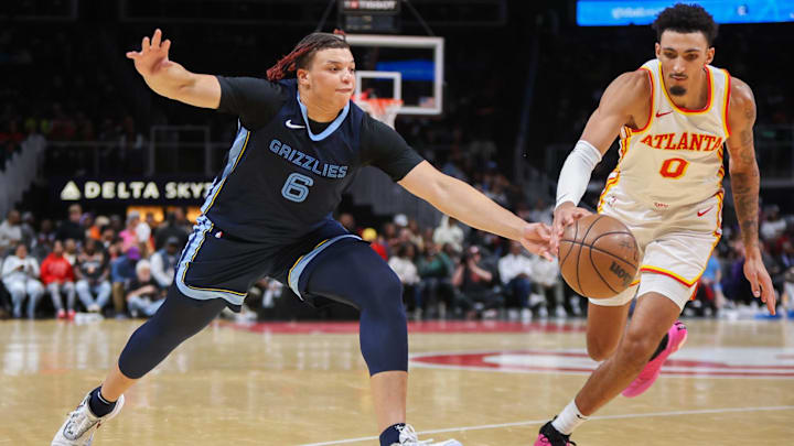Oct 12, 2023; Atlanta, Georgia, USA; Memphis Grizzlies forward Kenneth Lofton Jr. (6) reaches for a ball with Atlanta Hawks forward Miles Norris (0) in the fourth quarter at State Farm Arena. Mandatory Credit: Brett Davis-Imagn Images