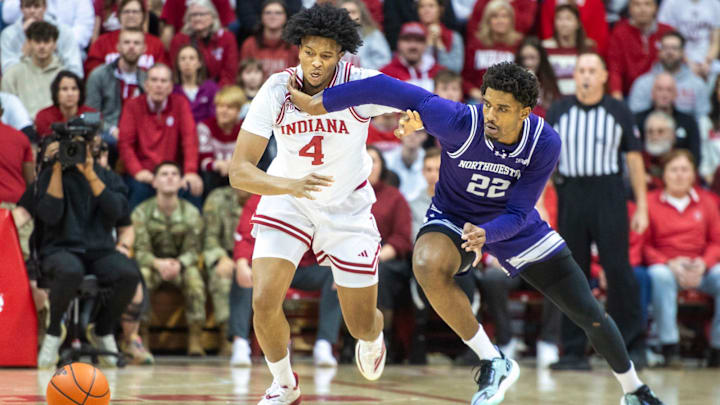 Indiana's Sam Alexis and Northwestern's Arrinten Page (22) head for a loose ball during the Indiana versus Northwestern men's basketball game at Simon Skjodt Assembly Hall on Tuesday, Feb. 24, 2026.