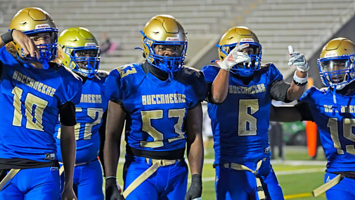 Mainland football players celebrate Braylyn Simmons' (6) touchdown during their Class 5A, Region 1 semifinal game against Lynn Haven Mosley on Friday, Nov. 21, 2025. The Buccaneers won 36-31.