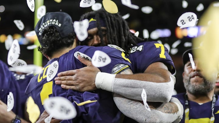 Michigan running backs Blake Corum, left, and Donovan Edwards hug during the trophy presentation after the 34-13 win over Washington at the national championship game at NRG Stadium in Houston on Monday, Jan. 8, 2024.