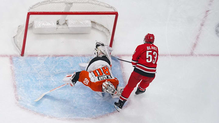 Dec 14, 2025; Raleigh, North Carolina, USA;  Philadelphia Flyers goaltender Dan Vladar (80) stops the shoot out attempt by Carolina Hurricanes right wing Jackson Blake (53) at Lenovo Center. Mandatory Credit: James Guillory-Imagn Images