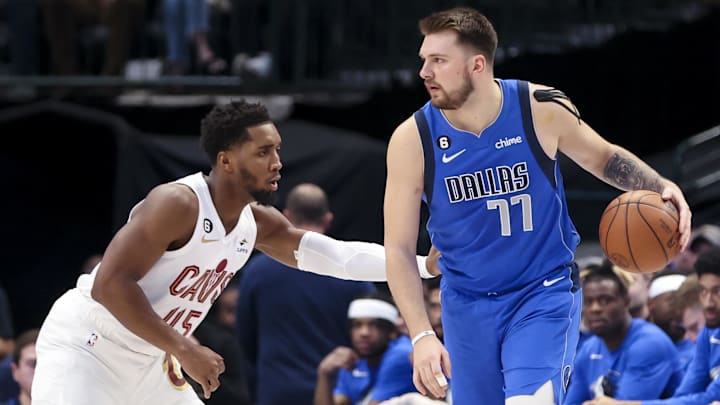 Dec 14, 2022; Dallas, Texas, USA;  Dallas Mavericks guard Luka Doncic (77) controls the ball as Cleveland Cavaliers guard Donovan Mitchell (45) defends during the first quarter at American Airlines Center. Mandatory Credit: Kevin Jairaj-Imagn Images