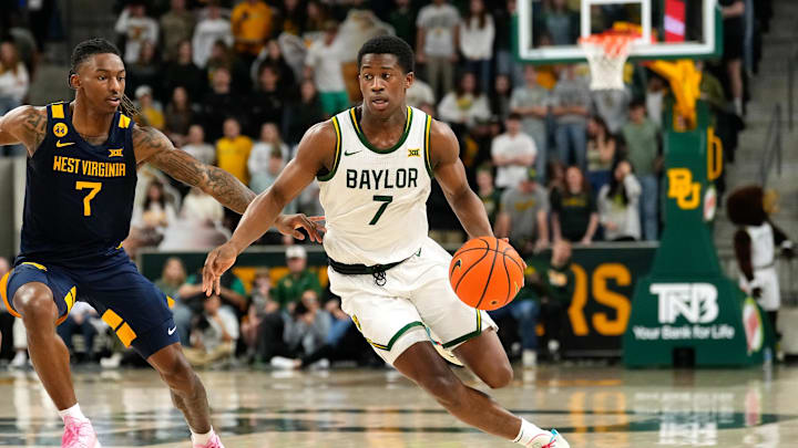 Feb 15, 2025; Waco, Texas, USA; Baylor Bears guard VJ Edgecombe (7) drives to the basket ahead of West Virginia Mountaineers guard Javon Small (7) during the second half at Paul and Alejandra Foster Pavilion. Mandatory Credit: Chris Jones-Imagn Images
