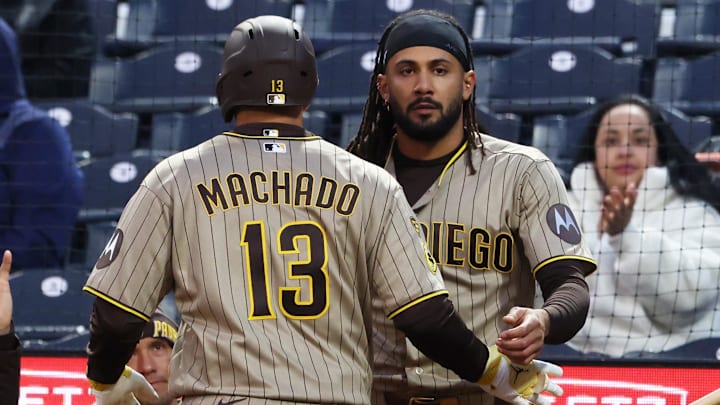 San Diego Padres right fielder Fernando Tatis Jr. greets third baseman Manny Machado. San Diego Padres right fielder Fernando Tatis Jr. greets third baseman Manny Machado.