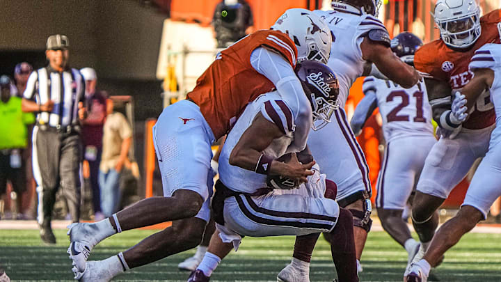 Mississippi State quarterback Michael Van Burn Jr. (0) is sacked by Texas Longhorns edge rusher Colin Simmons (11) during the game at Darrell K Royal-Texas Memorial Stadium in Austin Saturday, Sept. 28, 2024.