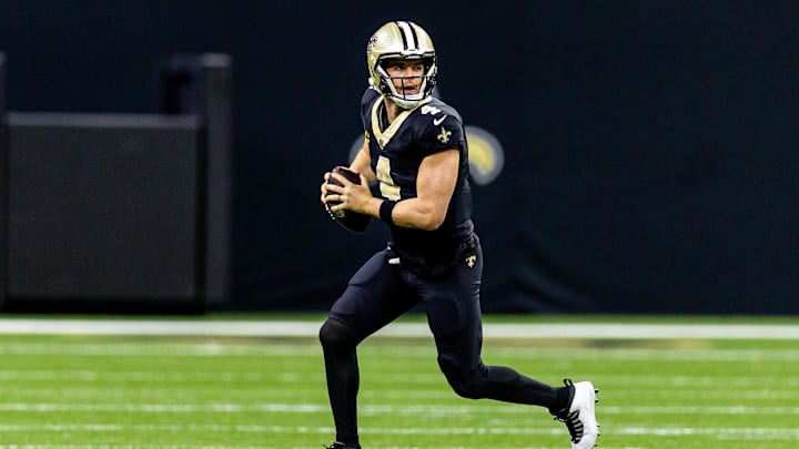 Nov 17, 2024; New Orleans, Louisiana, USA;  New Orleans Saints quarterback Derek Carr (4) rolls out the pocket against the Cleveland Browns during the first half at Caesars Superdome. Mandatory Credit: Stephen Lew-Imagn Images