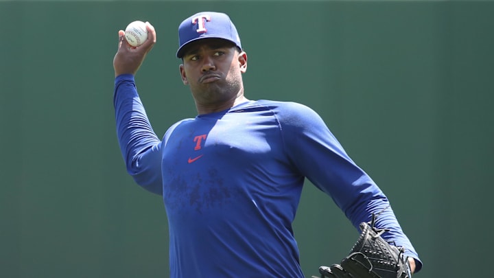 Texas Rangers pitcher Kumar Rocker throws in a blue practice T-shirt before a game. 