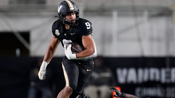 Vanderbilt tight end Eli Stowers (9) evades Ball State defensive back George Udo (10) during the fourth quarter at FirstBank Stadium in Nashville, Tenn., Saturday, Oct. 19, 2024.