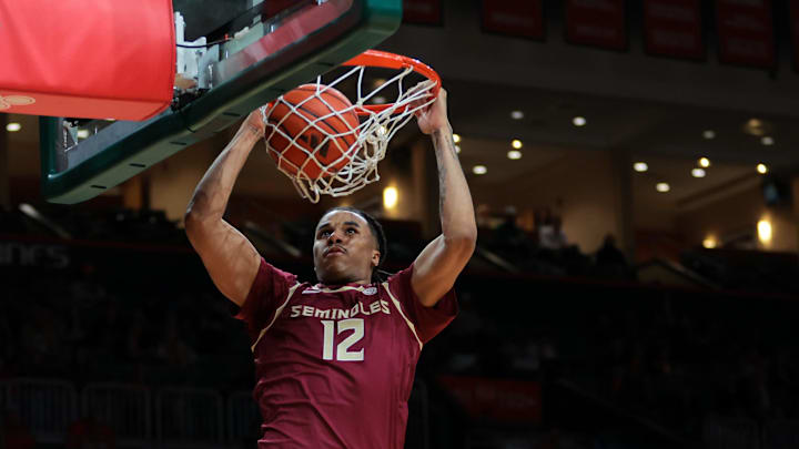Jan 8, 2025; Coral Gables, Florida, USA; Florida State Seminoles forward Malique Ewin (12) dunks against the Miami Hurricanes during the first half at Watsco Center. Mandatory Credit: Sam Navarro-Imagn Images
