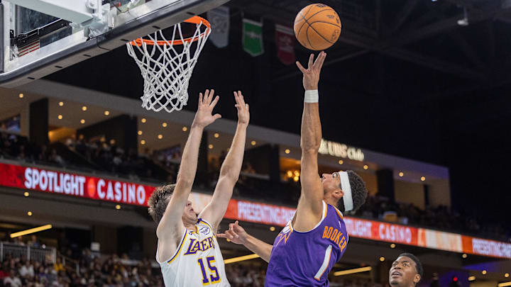 Oct 6, 2024; Palm Desert, California, USA; Phoenix Suns guard Devin Booker (1) shoots the ball against Los Angeles Lakers guard Austin Reaves (15) during the first half at Acrisure Arena. Mandatory Credit: David Frerker-Imagn Images