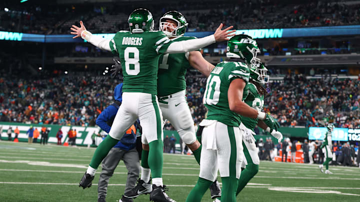 Jan 5, 2025; East Rutherford, New Jersey, USA; New York Jets quarterback Aaron Rodgers (8) celebrates his touchdown pass to New York Jets wide receiver Davante Adams (17) (not pictured) during the fourth quarter of their game against the Miami Dolphins at MetLife Stadium. Mandatory Credit: Ed Mulholland-Imagn Images