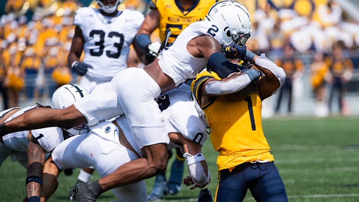 Penn State's KJ Winston brings down West Virginia's Jahiem White in the first half of a 2024 college football game. 