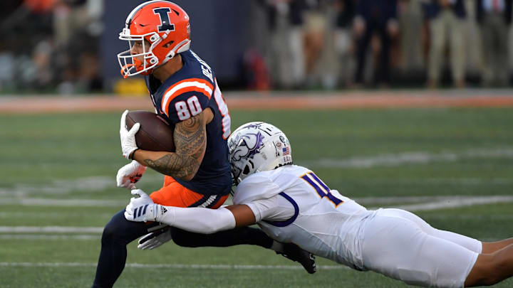 Aug 29, 2025; Champaign, Illinois, USA; Illinois Fighting Illini wide receiver Hank Beatty (80) runs the ball after a pass reception as Western Illinois Leathernecks defensive back Buju Aumua-Tuisavura (14) tackles during the first half at Memorial Stadium. Mandatory Credit: Ron Johnson-Imagn Images Aug 29, 2025; Champaign, Illinois, USA; Illinois Fighting Illini wide receiver Hank Beatty (80) runs the ball after a pass reception as Western Illinois Leathernecks defensive back Buju Aumua-Tuisavura (14) tackles during the first half at Memorial Stadium. Mandatory Credit: Ron Johnson-Imagn Images