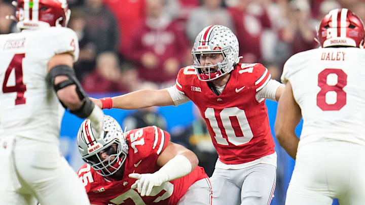 Ohio State Buckeyes quarterback Julian Sayin (10) lines up during the first half of the Big Ten Conference championship game against the Indiana Hoosiers at Lucas Oil Stadium in Indianapolis on Dec. 6, 2025. Ohio State Buckeyes quarterback Julian Sayin (10) lines up during the first half of the Big Ten Conference championship game against the Indiana Hoosiers at Lucas Oil Stadium in Indianapolis on Dec. 6, 2025.
