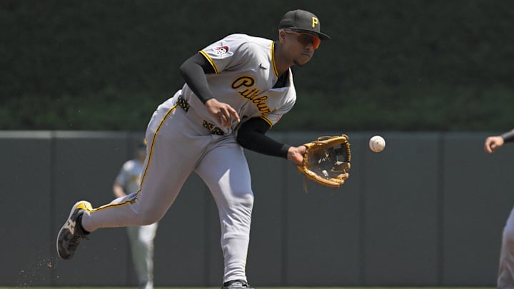 Jul 13, 2025; Minneapolis, Minnesota, USA;  Pittsburgh Pirates infielder Ke'Bryan Hayes (13) fields a ground ball against the Minnesota Twins during the first inning at Target Field. Mandatory Credit: Nick Wosika-Imagn Images