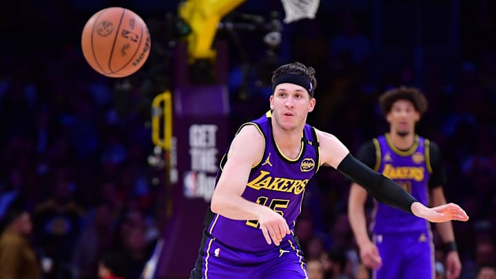 Feb 25, 2025; Los Angeles, California, USA; Los Angeles Lakers guard Austin Reaves (15) makes a pass against the Dallas Mavericks during the second half at Crypto.com Arena. Mandatory Credit: Gary A. Vasquez-Imagn Images