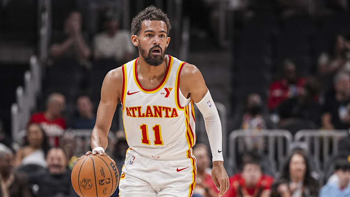 Oct 8, 2024; Atlanta, Georgia, USA; Atlanta Hawks guard Trae Young (11) controls the ball against the Indiana Pacers during the first half at State Farm Arena.