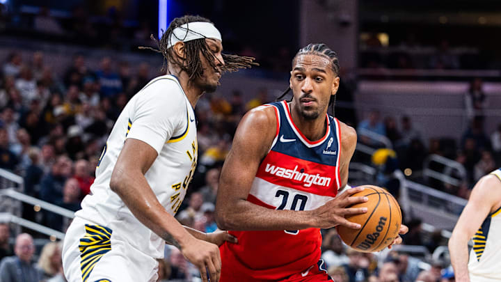 Apr 8, 2025; Indianapolis, Indiana, USA; Washington Wizards forward Alex Sarr (20) dribbles the ball while Indiana Pacers center Myles Turner (33)  defends in the second half at Gainbridge Fieldhouse. Mandatory Credit: Trevor Ruszkowski-Imagn Images