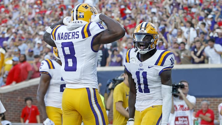 LSU Tigers wide receiver Brian Thomas Jr. (11) reacts with LSU Tigers wide receiver Malik Nabers (8) after a touchdown during the first half at Vaught-Hemingway Stadium.