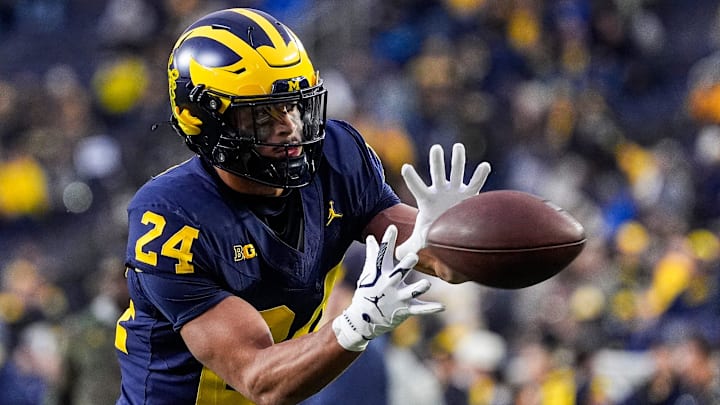 Michigan running back Bryson Kuzdzal (24) warms up ahead of the Purdue game at Michigan Stadium in Ann Arbor on Saturday, November 1, 2025.