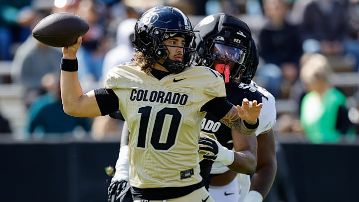 Apr 19, 2025; Boulder, CO, USA; Colorado Buffaloes quarterback Julian Lewis (10) and defensive end Arden Walker (53) during the spring game at Folsom Field. Apr 19, 2025; Boulder, CO, USA; Colorado Buffaloes quarterback Julian Lewis (10) and defensive end Arden Walker (53) during the spring game at Folsom Field.
