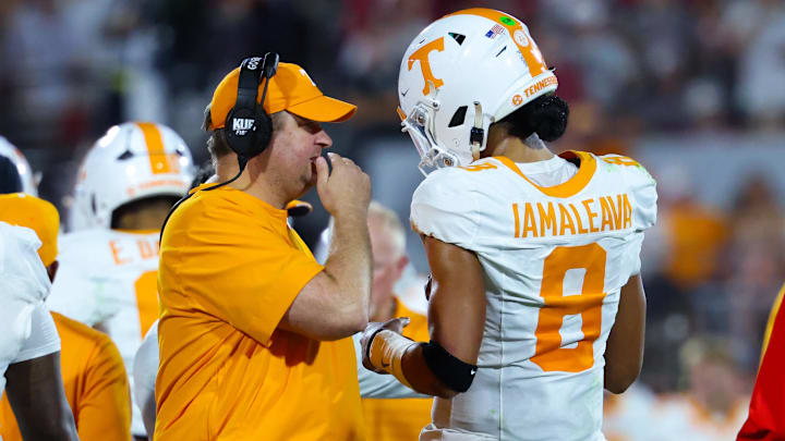 Sep 21, 2024; Norman, Oklahoma, USA; Tennessee Volunteers head coach Josh Heupel (left) speaks with Tennessee Volunteers quarterback Nico Iamaleava (8) during the first half against the Oklahoma Sooners at Gaylord Family-Oklahoma Memorial Stadium. Mandatory Credit: Kevin Jairaj-Imagn Images