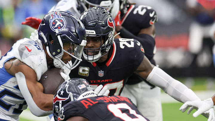 Nov 24, 2024; Houston, Texas, USA;Tennessee Titans running back Tony Pollard (20) rushes against Houston Texans safety Jimmie Ward (20) in the fourth quarter at NRG Stadium. Mandatory Credit: Thomas Shea-Imagn Images Nov 24, 2024; Houston, Texas, USA;Tennessee Titans running back Tony Pollard (20) rushes against Houston Texans safety Jimmie Ward (20) in the fourth quarter at NRG Stadium. Mandatory Credit: Thomas Shea-Imagn Images