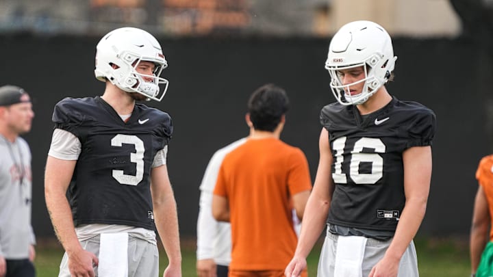 Texas quarterbacks Arch Manning (16) and Quinn Ewers talk during the team's first spring practice of