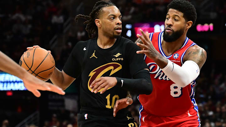 Dec 21, 2024; Cleveland, Ohio, USA; Cleveland Cavaliers guard Darius Garland (10) drives to the basket against Philadelphia 76ers forward Paul George (8) during the second half at Rocket Mortgage FieldHouse. Mandatory Credit: Ken Blaze-Imagn Images