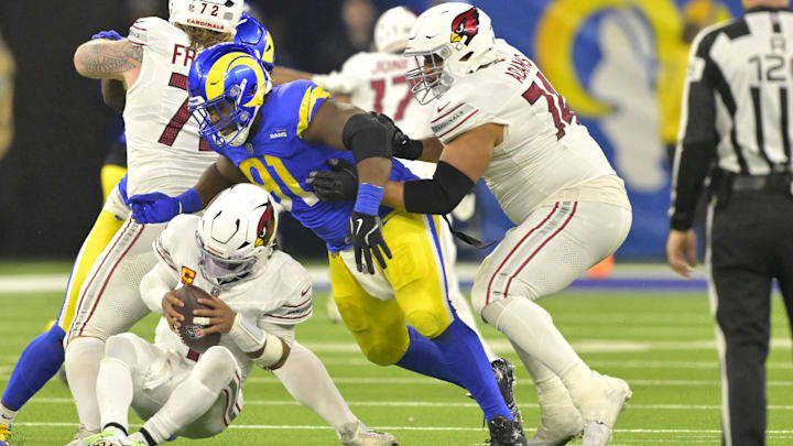 Dec 28, 2024; Inglewood, California, USA;  Los Angeles Rams defensive tackle Kobie Turner (91) sacks Arizona Cardinals quarterback Kyler Murray (1) in the second half at SoFi Stadium. Mandatory Credit: Jayne Kamin-Oncea-Imagn Images