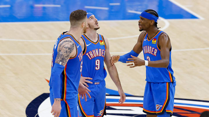 Isaiah Hartenstein, Alex Caruso and Shai Gilgeous-Alexander talk during Game 2 of the NBA Finals.