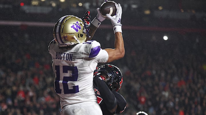 Washington Huskies wide receiver Denzel Boston catches a touchdown over Rutgers defensive back Robert Longerbeam 