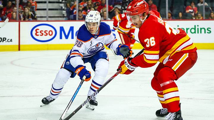 Sep 21, 2025; Calgary, Alberta, CAN; Edmonton Oilers left wing David Lewandowski (38) and Calgary Flames left wing Aydar Suniev (36) battles for the puck during the second period at Scotiabank Saddledome. Mandatory Credit: Sergei Belski-Imagn Images Sep 21, 2025; Calgary, Alberta, CAN; Edmonton Oilers left wing David Lewandowski (38) and Calgary Flames left wing Aydar Suniev (36) battles for the puck during the second period at Scotiabank Saddledome. Mandatory Credit: Sergei Belski-Imagn Images