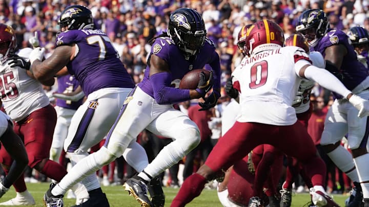 Oct 13, 2024; Baltimore, Maryland, USA; Baltimore Ravens running back Derrick Henry (22) scores a third quarter touchdown against the Washington Commanders at M&T Bank Stadium. Mandatory Credit: Mitch Stringer-Imagn Images