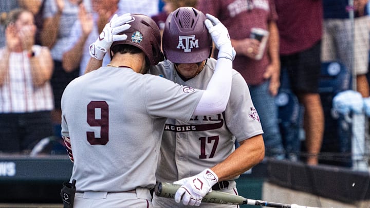 Jun 22, 2024; Omaha, NE, USA; Texas A&M Aggies third baseman Gavin Grahovac (9) and right fielder Jace Laviolette (17) embrace after a home run by Grahovac against the Tennessee Volunteers during the first inning at Charles Schwab Field Omaha. Mandatory Credit: Dylan Widger-Imagn Images