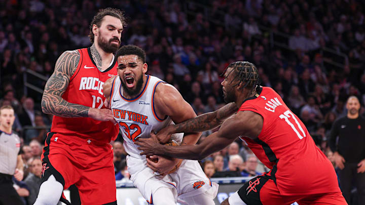 Feb 3, 2025; New York, New York, USA; New York Knicks center Karl-Anthony Towns (32) goes to the basket as Houston Rockets forward Tari Eason (17) and center Steven Adams (12) defend during the second half at Madison Square Garden. Mandatory Credit: Vincent Carchietta-Imagn Images
