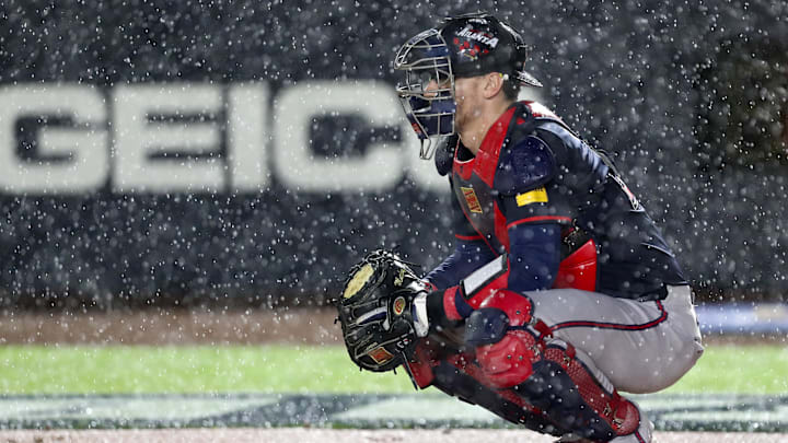Aug 2, 2025; Bristol, Tennessee, USA; Atlanta Braves catcher Sean Murphy (12) prepares to defend the plate as rain falls during the first inning of the Speedway Classic game against the Cincinnati Reds at Bristol Motor Speedway. Mandatory Credit: Randy Sartin-Imagn Images