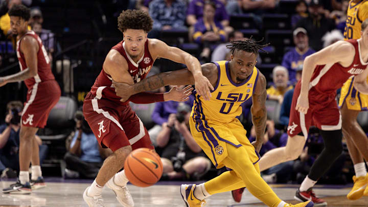Feb 10, 2024; Baton Rouge, Louisiana, USA;  Alabama Crimson Tide guard Mark Sears (1) steals the ball from LSU Tigers guard Trae Hannibal (0) during the second half at Pete Maravich Assembly Center. Mandatory Credit: Stephen Lew-Imagn Images