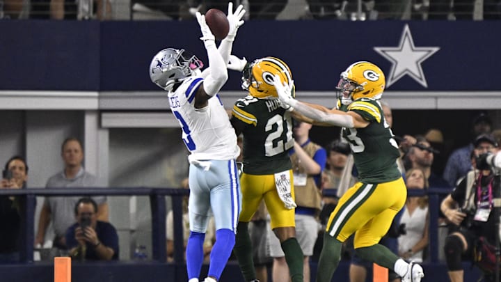 Dallas Cowboys wide receiver George Pickens makes a catch against Green Bay Packers CB Nate Hobbs and S Evan Williams.