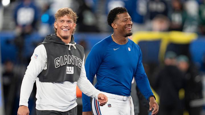 New York Giants quarterback Jaxson Dart (6) and New York Giants quarterback Jameis Winston (19) smile during warmups before a Thursday Night Football game between the New York Giants and the Philadelphia Eagles at MetLife Stadium in East Rutherford on Oct. 9, 2025.