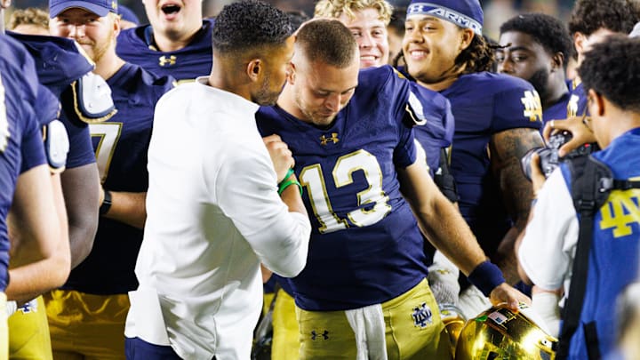 Notre Dame head coach Marcus Freeman, left, celebrates with quarterback CJ Carr (13) after winning a NCAA football game 56-30 against Purdue at Notre Dame Stadium on Saturday, Sept. 20, 2025, in South Bend.