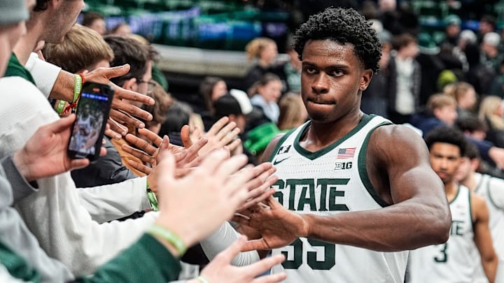 Michigan State forward Coen Carr (55) high-fives student fans after 73-51 win over Minnesota at Breslin Center in East Lansing on Tuesday, Jan. 28, 2025.