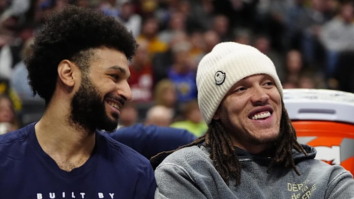 Feb 3, 2025; Denver, Colorado, USA; Denver Nuggets forward Aaron Gordon (32) and guard Jamal Murray (27) on the bench in the second half against the New Orleans Pelicans at Ball Arena. Mandatory Credit: Ron Chenoy-Imagn Images