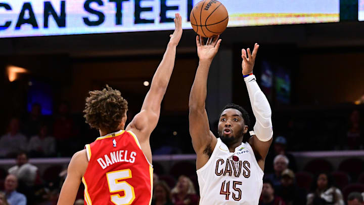 Nov 2, 2025; Cleveland, Ohio, USA; Cleveland Cavaliers guard Donovan Mitchell (45) shoots over the defense of  Atlanta Hawks guard Dyson Daniels (5) during the second half at Rocket Arena. Mandatory Credit: Ken Blaze-Imagn Images