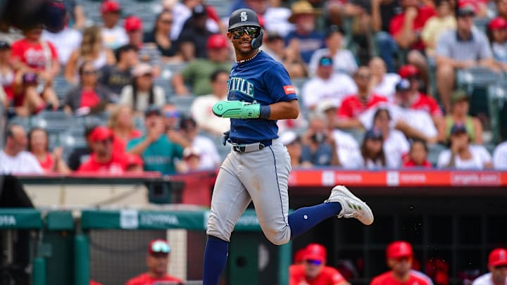 Julio Rodriguez (44) runs home to score against the Los Angeles Angels during the tenth inning at Angel Stadium.