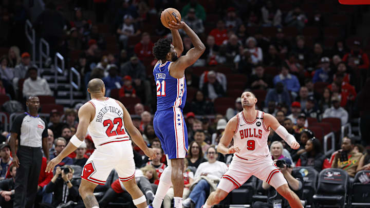 Dec 8, 2024; Chicago, Illinois, USA; Philadelphia 76ers center Joel Embiid (21) shoots against Chicago Bulls center Nikola Vucevic (9) during the first half at United Center. Mandatory Credit: Kamil Krzaczynski-Imagn Images