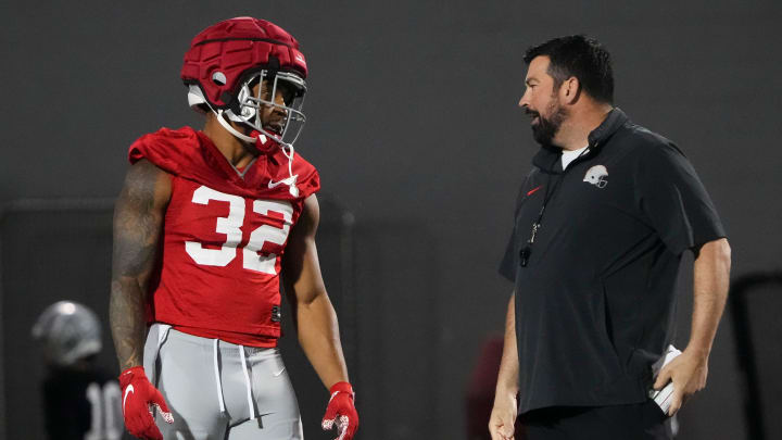 Mar 7, 2024; Columbus, OH, USA; Ohio State Buckeyes head coach Ryan Day talks to running back TreVeyon Henderson (32) during spring football practice at the Woody Hayes Athletic Center.