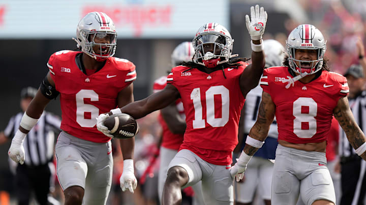 Aug 31, 2024; Columbus, OH, USA; Ohio State Buckeyes cornerback Denzel Burke (10) celebrates an interception with safety Sonny Styles (6) and safety Lathan Ransom (8) during the first half of the NCAA football game against the Akron Zips at Ohio Stadium.