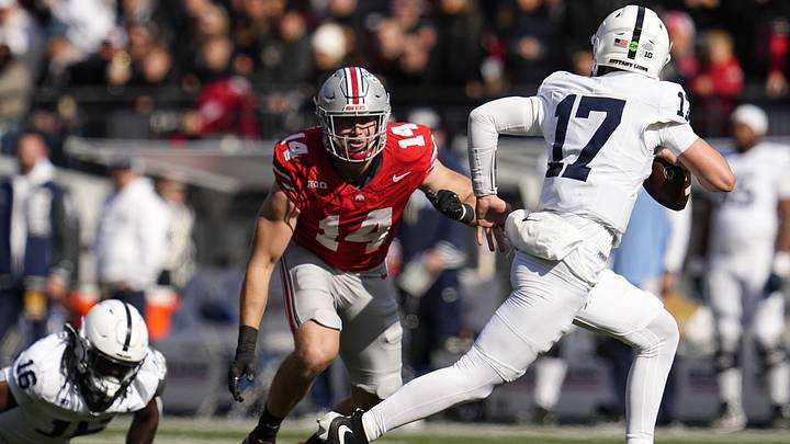 Ohio State Buckeyes defensive lineman Beau Atkinson pursues Penn State Nittany Lions quarterback Ethan Grunkemeyer Ohio State Buckeyes defensive lineman Beau Atkinson pursues Penn State Nittany Lions quarterback Ethan Grunkemeyer